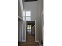 Welcoming entryway with soaring ceiling and sleek, modern flooring that leads to a naturally-lit living space at 3667 Travertine Dr, Lancaster, SC 29720