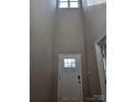 Bright entryway featuring a soaring ceiling, window transom, and a solid front door providing ample natural light at 3667 Travertine Dr, Lancaster, SC 29720