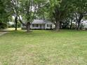 A single-story home surrounded by mature trees, offering a peaceful and shaded setting at 3672 Nc Hwy 127 Hwy, Hickory, NC 28602