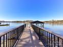 Dock leading out to the lake with blue skies and trees in the background at 4046 Rhynland Dr, Sherrills Ford, NC 28673