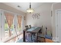Bright dining room with table, chairs, and french doors to the outside area at 4710 Nijinsky Ct, Charlotte, NC 28216