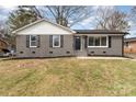 Charming gray brick home featuring a well-maintained lawn and inviting front entrance at 510 Colony Acres Dr, Charlotte, NC 28217