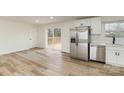 Bright kitchen featuring stainless steel appliances, white cabinetry, and sliding door to deck at 510 Colony Acres Dr, Charlotte, NC 28217