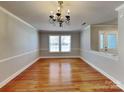 Traditional dining area with hardwood floors, decorative lighting, and bright windows at 5513 Hammermill Dr, Harrisburg, NC 28075