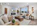 Inviting living room showcasing stylish furnishings, a fireplace, and plenty of natural light at 554 Mountain View Dr, Monroe, NC 28110