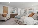 Serene main bedroom with neutral tones, a dresser, and a comfortable sitting area perfect for relaxing at 554 Mountain View Dr, Monroe, NC 28110