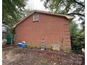 Side view of brick home with mature landscaping at 5635 Ruth Dr, Charlotte, NC 28215