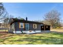 Charming one-story home with a landscaped yard, a carport, and newly painted exterior at 627 Westway Dr, Gastonia, NC 28054