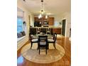 Cozy dining area with a bay window, cushioned seating, and kitchen access at 645 Beaty St, Davidson, NC 28036