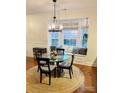 Elegant dining area with bay window, cushioned seating, and stylish chandelier at 645 Beaty St, Davidson, NC 28036