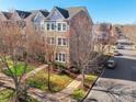 Aerial view of a brick townhome showcasing mature trees, landscaping, and a desirable neighborhood setting at 7147 Brighton Park Dr, Mint Hill, NC 28227