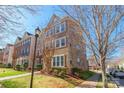 Attractive brick townhouse showcasing well-maintained landscaping and a welcoming neighborhood setting at 7147 Brighton Park Dr, Mint Hill, NC 28227