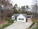 Charming home featuring a spacious driveway, well-kept lawn, and detached garage for extra parking at 7219 Morningdew Ct, Denver, NC 28037