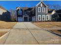 Charming two-story home with a two-car garage, large driveway and traditional architectural details at 8231 Annsborough Nw Dr, Concord, NC 28027