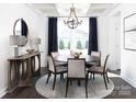 Modern dining room with a round table, elegant chandelier, and neutral decor at 91 Belwood Dr, Belmont, NC 28012