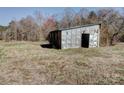 Rustic outbuilding with a metal roof on a grassy lot at 966 Marys Grove Rd, Cherryville, NC 28021