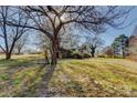 Property view with grassy lawn and mature trees, showing house and outbuildings at 966 Marys Grove Rd, Cherryville, NC 28021