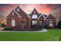 Inviting two-story brick home with manicured lawn and tasteful landscaping at 1038 Rolling Park Ln, Fort Mill, SC 29715