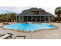 Backyard pool and patio area featuring a diving board, hot tub, and screened porch at 1038 Rolling Park Ln, Fort Mill, SC 29715