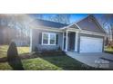 Charming home featuring modern siding, well-manicured landscaping, and an attached garage at 1123 Fieldstone Rd, Mooresville, NC 28115