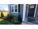 Inviting front entrance with dark blue door and stylish landscaping at 1123 Fieldstone Rd, Mooresville, NC 28115