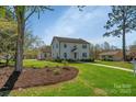 Beautiful two-story home with lush green lawn, mature trees, and well-kept landscaping at 113 Windsong Ct, Gastonia, NC 28056