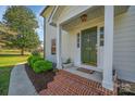 Charming front door with brick steps, manicured landscaping, and a welcoming entrance at 113 Windsong Ct, Gastonia, NC 28056