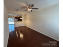 Spacious living room boasting sleek hardwood floors and an open layout that flows into the kitchen at 13615 Browhill Ln, Charlotte, NC 28278