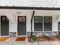 Close-up of a townhouse entrance, featuring a dark door with glass panel and stone accents at 1409 Kenilworth Ave, Charlotte, NC 28203