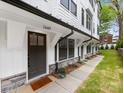 Stylish townhouse entrance with a dark front door, stone accents, and manicured lawn at 1409 Kenilworth Ave, Charlotte, NC 28203