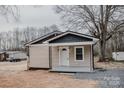 Charming home exterior with light siding, black roof trim, and a welcoming front porch at 176 Gravel Hill Ct, Taylorsville, NC 28681