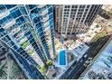 Aerial view of a rooftop pool with lounge chairs among tall condos in the city at 210 N Church St # 1507, Charlotte, NC 28202