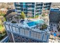 Rooftop pool deck with lounge chairs and landscaping for the high-rise condo building at 210 N Church St # 1507, Charlotte, NC 28202