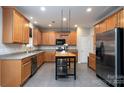 Kitchen boasts stainless steel appliances, tile floors, ample cabinets, and a center island with a butcher block top at 303 Basswood Ct, Clover, SC 29710