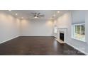 Bright living room features a fireplace, hardwood floors, recessed lighting, and a modern ceiling fan at 303 Basswood Ct, Clover, SC 29710