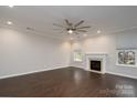 Bright living room features a fireplace, hardwood floors, recessed lighting, and a modern ceiling fan at 303 Basswood Ct, Clover, SC 29710