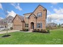 Inviting brick home featuring a manicured lawn and lovely landscaping at 3045 Bronwood Pl, Lancaster, SC 29720