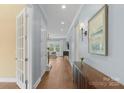 Light-filled hallway showcasing hardwood floors and neutral wall colors at 3045 Bronwood Pl, Lancaster, SC 29720
