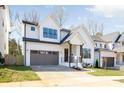 Beautiful two-story home with white siding, black framed windows and a well-manicured lawn at 3937 Plainview Rd, Charlotte, NC 28208