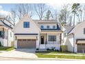 Charming two-story home featuring board and batten siding, a two-car garage, and professionally landscaped yard at 3949 Plainview Rd, Charlotte, NC 28208