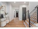 Inviting foyer with hardwood floors, modern staircase, and elegant decor that leads to the rest of the home at 3949 Plainview Rd, Charlotte, NC 28208