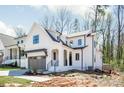 Modern farmhouse with two-car garage, board and batten siding, and covered front porch at 3953 Plainview Rd, Charlotte, NC 28208