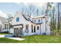 Modern farmhouse with two-car garage, board and batten siding, and covered front porch at 3953 Plainview Rd, Charlotte, NC 28208