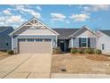 Charming single-Gathering home featuring a two-car garage and well-maintained landscaping at 4317 Stream Dale Nw Cir, Concord, NC 28027
