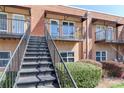 View of outdoor stairs leading to the units with private balconies and well-maintained shrubbery at 452 S Main St # F, Davidson, NC 28036