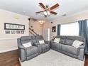 Inviting living room showcasing hardwood floors, comfortable seating, and staircase access at 4708 Chantress Ln, Monroe, NC 28110