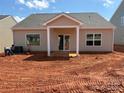 The back of the home has a small covered porch, sliding glass doors, and large windows at 5712 Skinny Ln, Charlotte, NC 28215