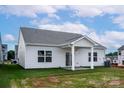 Well-maintained home with a covered patio and a spacious backyard, perfect for outdoor activities at 5712 Skinny Ln, Charlotte, NC 28215