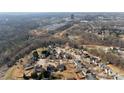 Neighborhood aerial view with trees, pond, and winding pathways at 576 Putting Dr, Fort Mill, SC 29715