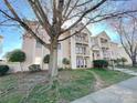 Beautiful multi-story condo building surrounded by mature trees and lush green lawns at 6132 Meadow Rose Ln, Charlotte, NC 28215